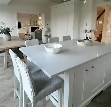 Modern white quartz kitchen island by RH Stone Surfaces