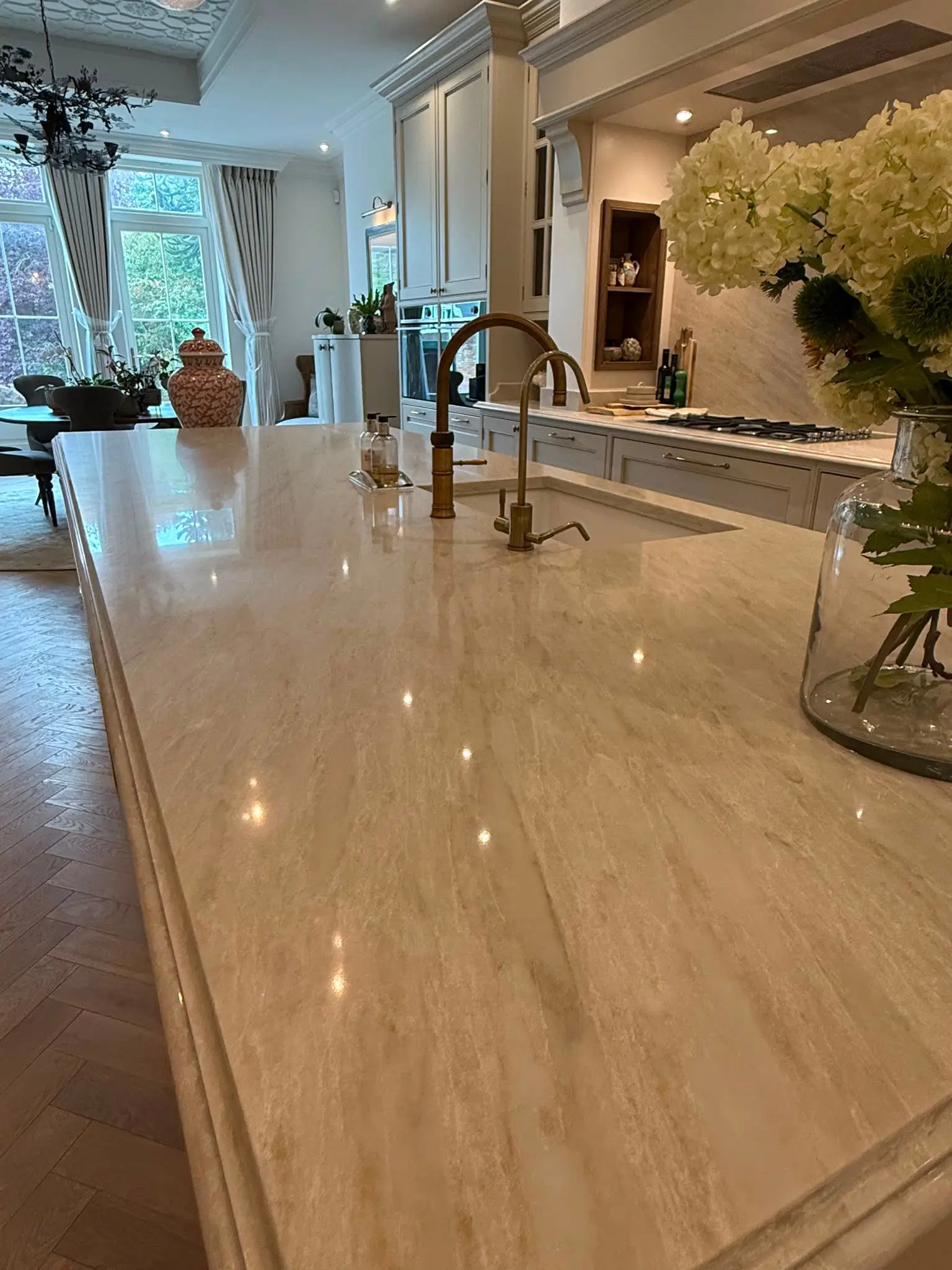 Taj Mahal quartz island worktop with inset sink and brass taps