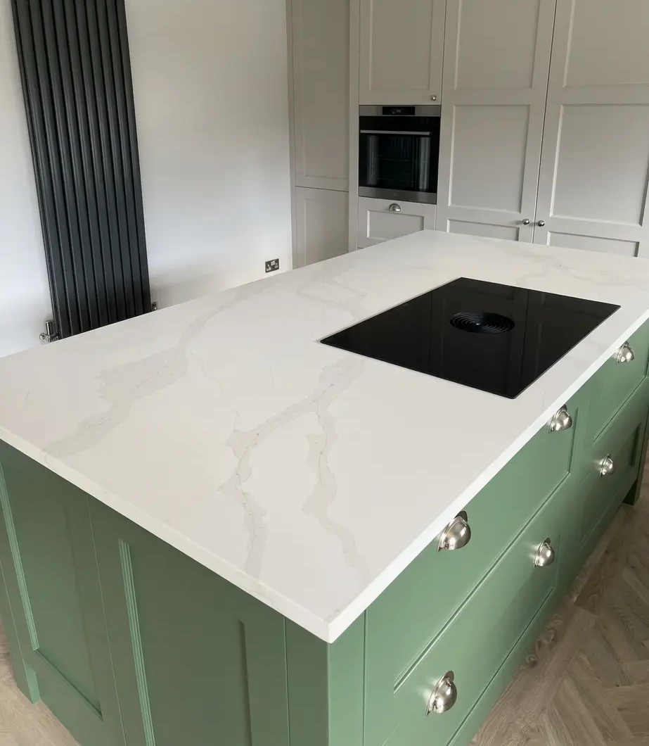 White quartz kitchen island with green cabinets for North Shields by RH Stone Surfaces