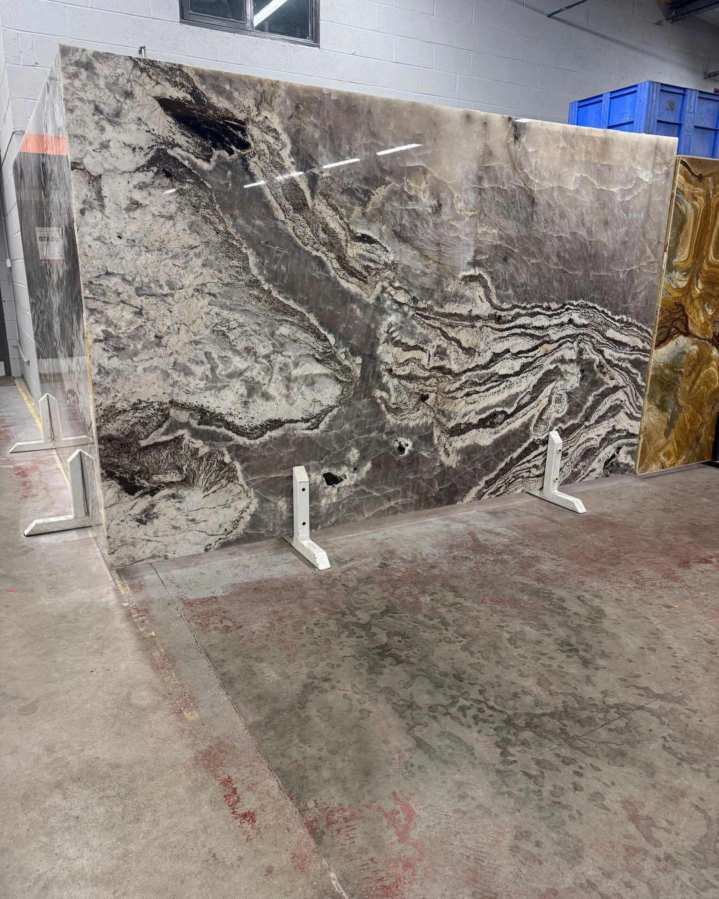 Large grey granite slab with flowing natural pattern in the showroom