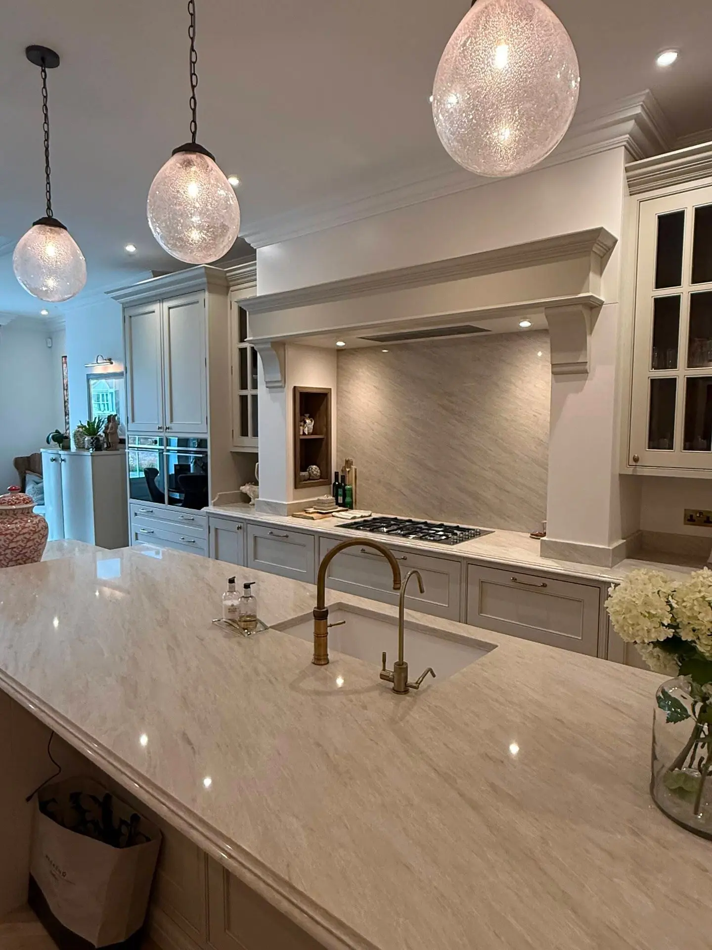 Light quartz island and splashback shown as Roker kitchen inspiration