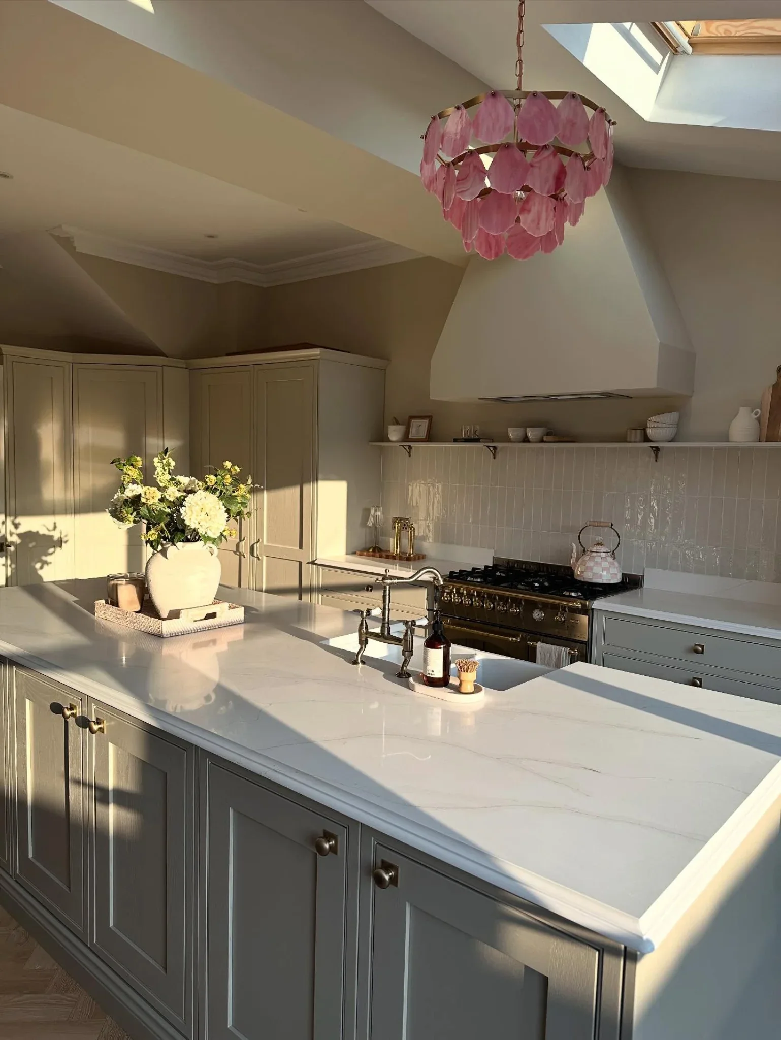 Light veined quartz island with classic kitchen cabinetry.
